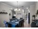 Open dining room with a chandelier and view of kitchen at 3946 Bedford Ave, Winter Haven, FL 33884