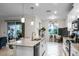 Bright kitchen with an island, white cabinets, and access to a patio at 3946 Bedford Ave, Winter Haven, FL 33884