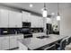 Modern kitchen with white cabinets, granite countertops, and stainless steel appliances at 3946 Bedford Ave, Winter Haven, FL 33884