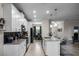 Open kitchen boasts white cabinets, an island, and a view into the dining area at 3946 Bedford Ave, Winter Haven, FL 33884
