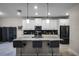 Modern kitchen with white cabinets, breakfast bar, and stainless steel appliances at 3946 Bedford Ave, Winter Haven, FL 33884