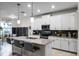 Modern kitchen with white cabinets, large island, and breakfast bar at 3946 Bedford Ave, Winter Haven, FL 33884