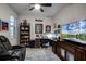 Home office features a large desk, comfortable seating and a large TV at 3946 Bedford Ave, Winter Haven, FL 33884
