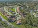 Aerial view of a community with houses, trees, and roads at 3966 Oak Loop # 13, Mulberry, FL 33860