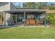 Spacious backyard with a covered patio, grill, and grassy area at 3966 Oak Loop # 13, Mulberry, FL 33860