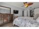 Bedroom with wood dresser and floral bedding at 3966 Oak Loop # 13, Mulberry, FL 33860