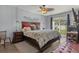 Main bedroom with sliding door to backyard and ceiling fan at 3966 Oak Loop # 13, Mulberry, FL 33860