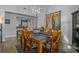 Dining area with table for six, chandelier, and access to kitchen at 3966 Oak Loop # 13, Mulberry, FL 33860