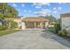 Tan two-story home with carport and landscaped yard at 3966 Oak Loop # 13, Mulberry, FL 33860