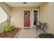 Inviting front entry with red door, wreath, and small sitting area at 3966 Oak Loop # 13, Mulberry, FL 33860