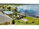 Landscaped gardens, pool, and clubhouse near lake at 4193 Limerick Dr, Lake Wales, FL 33859