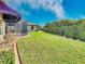 Expansive backyard featuring a large grassy area and privacy hedge at 4193 Limerick Dr, Lake Wales, FL 33859