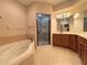 Elegant bathroom with soaking tub, walk-in shower, and double vanity at 4193 Limerick Dr, Lake Wales, FL 33859