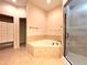 Spa-like bathroom featuring a corner soaking tub and walk-in shower at 4193 Limerick Dr, Lake Wales, FL 33859