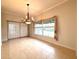 Bright dining room features tile floors, chandelier, and view to backyard at 4193 Limerick Dr, Lake Wales, FL 33859