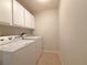 Convenient laundry room with washer, dryer, and overhead cabinets at 4193 Limerick Dr, Lake Wales, FL 33859