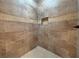 Walk-in shower with neutral tile and built-in niche at 4193 Limerick Dr, Lake Wales, FL 33859