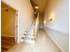 A view of a carpeted staircase with wooden handrail at 4193 Limerick Dr, Lake Wales, FL 33859