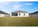Spacious backyard with grassy area and white vinyl fence at 425 Riders Loop, Auburndale, FL 33823