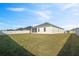 Expansive backyard with grassy lawn and privacy fence at 425 Riders Loop, Auburndale, FL 33823