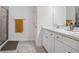 Bathroom with double vanity, large mirror, and walk-in shower at 425 Riders Loop, Auburndale, FL 33823