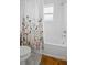 Bathroom with floral shower curtain and bathtub at 425 Riders Loop, Auburndale, FL 33823