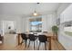Open dining room with wooden table and view into adjacent bedroom at 425 Riders Loop, Auburndale, FL 33823
