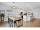 Bright kitchen features island, stainless steel appliances, and white shaker cabinets at 425 Riders Loop, Auburndale, FL 33823