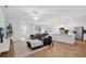 Open living space with L-shaped sofa and kitchen island at 425 Riders Loop, Auburndale, FL 33823