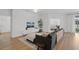 Living room with sectional sofa, mounted TV, and access to bedroom at 425 Riders Loop, Auburndale, FL 33823