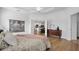 Main bedroom with king-size bed, dresser, and access to kitchen at 425 Riders Loop, Auburndale, FL 33823