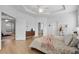 Main bedroom with king bed, dresser, and access to other rooms at 425 Riders Loop, Auburndale, FL 33823