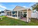Screened patio with seating area and backyard access at 426 Allison Ave, Davenport, FL 33897