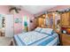 Main bedroom with pink walls, blue bedding, and an ensuite bathroom at 426 Allison Ave, Davenport, FL 33897