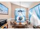 Charming breakfast nook with stained glass light fixture and blue curtains at 426 Allison Ave, Davenport, FL 33897