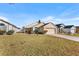 Tan one-story house with a two-car garage and grassy yard at 426 Allison Ave, Davenport, FL 33897