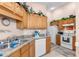 Well-equipped kitchen with wood cabinets, granite countertops, and modern appliances at 426 Allison Ave, Davenport, FL 33897