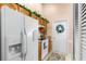 Kitchen boasts ample cabinet space, a refrigerator with ice maker, and a door to outdoors at 426 Allison Ave, Davenport, FL 33897