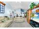 Open living room with high ceilings, neutral color palette, and a view of the entryway at 426 Allison Ave, Davenport, FL 33897