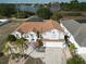 Single-Gathering home with a brown roof, landscaping, and a two-car garage at 437 Grand Reserve Dr, Davenport, FL 33837
