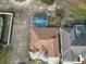 Single-Gathering home with brown roof, pool, and surrounding landscape at 437 Grand Reserve Dr, Davenport, FL 33837