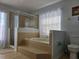 Bathroom with a large garden tub and shower at 437 Grand Reserve Dr, Davenport, FL 33837