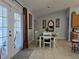 Dining area with a wooden table and white chairs near kitchen at 437 Grand Reserve Dr, Davenport, FL 33837