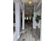 Bright entryway with grey tile floors and view of living room at 437 Grand Reserve Dr, Davenport, FL 33837