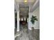 Bright entryway with grey tile floors and view of living room at 437 Grand Reserve Dr, Davenport, FL 33837