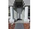 White front door with columns and a walkway at 437 Grand Reserve Dr, Davenport, FL 33837