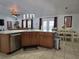 Island kitchen with stainless steel appliances and wood cabinets at 437 Grand Reserve Dr, Davenport, FL 33837