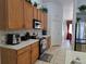 Modern kitchen with wood cabinets and stainless steel appliances at 437 Grand Reserve Dr, Davenport, FL 33837