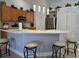 Kitchen with wood cabinets, island, and stainless steel appliances at 437 Grand Reserve Dr, Davenport, FL 33837