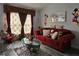 Living room with red couch, Mickey Mouse decor, and a coffee table at 437 Grand Reserve Dr, Davenport, FL 33837